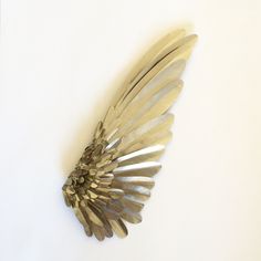 a silver brooch sitting on top of a white table