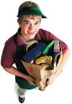 a young boy holding a bag full of items