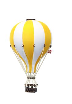 a yellow and white hot air balloon flying in the sky