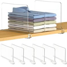 a shelf with several folded shirts on it and four clear acrylic holders for each shirt