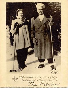 an old black and white photo of two people on skis