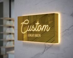 a sign that says custom on it in front of a white wall with gold lettering