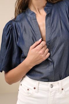 Bring a chic vibe to your everyday looks with the Lulus Contemporary Crush Dark Blue Chambray Puff Sleeve Button-Up Top! Lightweight woven chambray fabric shapes this stylish top that has pleated-like detailing at the shoulders and short puff sleeves with elastic at the cuffs. Crew neckline tops a functional, hidden button placket that runs down the bodice to rounded hems. Fit: This garment fits true to size. Length: Size medium measures 25" from shoulder to hem. Bust: Great for any cup size. Wa Chic Button-up Puff Sleeve Top For Work, Chic Puff Sleeve Button-up Top For Work, Denim Blue Button-up Workwear Blouse, Denim Blue Chambray Top With Button Closure, Chambray Denim Blue Top With Button Closure, Chic Button-up Puff Sleeve Top With Button Closure, Chic Puff Sleeve Top With Button Closure For Work, Fitted Denim Top For Workwear, Chic Short Sleeve Denim Top For Day Out