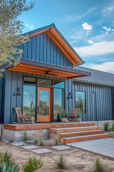 Sleek barndominium facade featuring mixed siding, sliding barn door, and welcoming front porch Barndominium Facade, Barndominiums On A Budget, Tin House