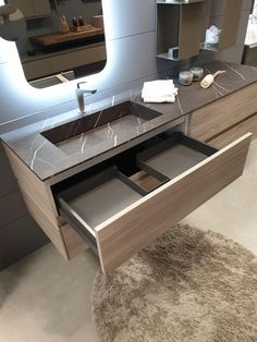 a bathroom vanity with two drawers and a mirror in the back drop off drawer area