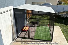 a dog is in its cage outside on the grass and next to it is a door