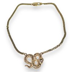 Embrace bold sophistication with the Python Necklace, a striking piece designed to capture attention. This gold-filled snake necklace features an intricately detailed coiled serpent pendant, symbolizing power and transformation. Set on a sturdy yet elegant chain, the serpent pendant boasts a polished finish, making it the perfect statement piece for any occasion. Lightweight and versatile, this snake necklace seamlessly elevates your style, whether for a night out or everyday wear. The timeless design and luxurious gold tones make this necklace an essential addition to your jewelry collection. Exposure to the salt from sweat can cause your pieces to become dull. Be mindful that perfume, hairspray and hand lotions may tarnish your gold filled jewelry due to the harsh chemicals they contain. Halo Jewelry, The Serpent, Gold C, Crystal Eye, Snake Necklace, Hand Lotion, Watch Necklace, Polish Jewelry, Gold Filled Jewelry