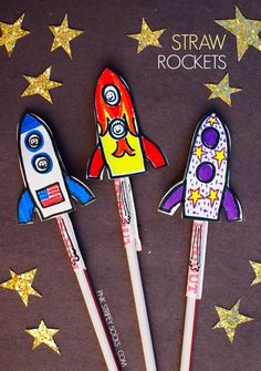 three paper rocket rockets sitting on top of each other with gold stars around them and the words straw rockets written in white ink