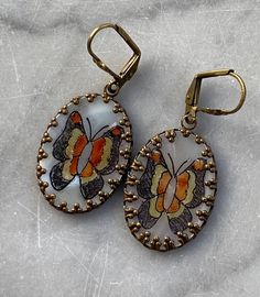 Vintage Mother of Pearl Painted Butterfly Cameo Dangle Earrings. These fun 1970's cameos are set in brass settings. 1 inch drop and .75 inch wide. Nickel free plated brass shell lever back ear wires. I can swap out these shell ear wires for a basic ear wire if you prefer. Comes boxed and ready for gift giving! Custom orders are always welcome! Painted Butterfly, Brass Shell, Pearl Paint, Crystal Drop Earrings, Crystal Drop, Etsy Earrings Dangle, Ear Wire, Ear Wires, Crystal Rhinestone