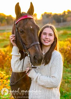 a girl is holding the reigns of a horse