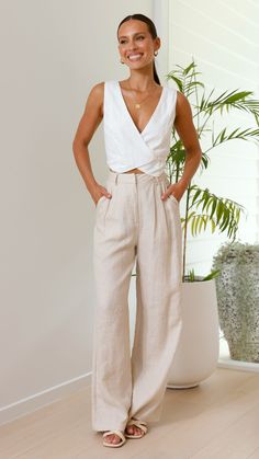 Details - Cropped length - V-Neckline - Wrap detail - Inner side button closure - Front hook and loop closure - Lined - 55% Linen 45% Viscose Get the look Ukko Heel - Camel Rafia & Tillie Pants - Oatmeal Model SIZE AND FIT -Sizing is standard for this style Linen Pants Women Casual, Linen Pants Formal Outfit, Tailor Made Clothes Women, White And Beige Outfits, Linen Crop Top Outfit, Women Linen Outfit, Summer Vest Outfits For Women, Wrap Pants Outfit, White Pants Outfit Casual