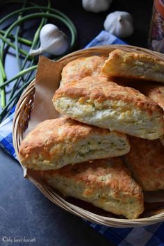 a basket filled with cheesy biscuits on top of a table