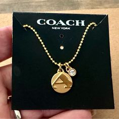 Brand New Without Tags And Absolutely Gorgeous Describes This Authentic Coach Brushed Gold-Tone Initial “A” With Crystal Accent Charm Pendant Beautifully Displayed On This Genuine 18k/.925 Necklace. Designer Trademark Stamped Coach On The Backside Of The Pendant. Necklace Measures 18” In Length. Lobster Claw Clasp. Gold-Toned. *** Please Note - This Necklace Will Ship In A Small Black Velvet Drawstring Dust Bag And Does Not Include The Coach Necklace Card As Seen In Main Picture*** Everyday Gold Coach Jewelry, Coach Gold Jewelry For Anniversary, Coach Round Jewelry For Anniversary, Gold Coach Jewelry For Anniversary, Classic Coach Jewelry For Gifts, Coach Necklace, Initial A, Coach Jewelry, Coach New York