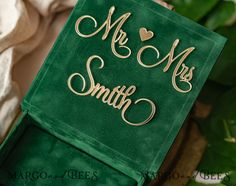 a green box with gold lettering on it and a plant in the background that says mr and mrs smith