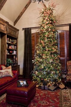 a living room with a christmas tree in the corner