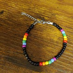 Handmade Beaded Pride Bracelet. Made With Seed Beads And Black Wax Cord With 1 1/2" Of Chain To Make This An Adjustable Bracelet. Colors Used: Red, Orange, Yellow, Green, Blue, Purple, And Black. Used A Lobster Clasp As A Finish. Fits Size 7 1/2 - 9" Wrist. Makes A Perfect Gift. Adjustable Black Beaded Bracelets With Colorful Beads, Black Beaded Bracelet As Gift, Black Beaded Chain Bracelet For Gift, Gift Black Beaded Chain Bracelet, Black Bohemian Beaded Bracelet With Colorful Beads, Bohemian Black Beaded Bracelets With Beaded Chain, Casual Black Beaded Bracelets With Large Beads, Casual Black Beaded Bracelet With Large Beads, Betsey Johnson Bracelet