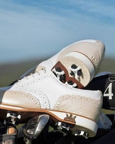 a pair of shoes sitting on top of a motorcycle