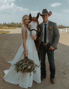 a man and woman standing next to a horse