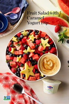 fruit salad with caramel yogurt dip in a bowl on top of a table