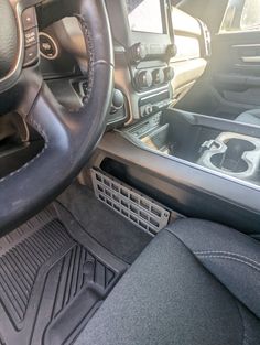 the interior of a car with black leather seats and dashboard controls, including steering wheel