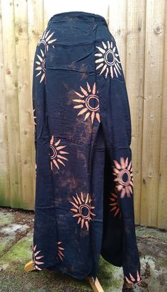 Gorgeous and very flattering long skirt. Ankle length straight skirt with two front splits, split ends just above the knee. Black with bleached style sun print. One size, elasticated to back of waist.  Fits approximately 10-16. Team with the matching tie front shrug top for a stunning outfit. Fair trade. 100% rayon. Spring Vacation Ankle-length Maxi Skirt, Bohemian Ankle-length Flowy Skirt, Flowy Cotton Ankle-length Maxi Skirt, Beach Ankle-length Maxi Skirt, Bohemian Ankle-length Cotton Skirt, Split Skirt, Split Ends, Stunning Outfits, Straight Skirt