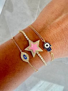 Just in time for the holidays, we've bundled some of our most-loved jewels into curated, specially priced gift sets for every taste! Our New Years prediction: the Destiny Calling Bracelet Trio is your must-have power squad of beautiful protection for 2022. Your new lineup of vibe guardians includes the glam-and-glowing Pink Star Crystal Bracelet, the delicate and dazzling Third Eye Open Bracelet, and the pint-sized powerhouse Onyx Hamsa Bracelet. Arm yourself with these gorgeous gems and see wha Pink Adjustable Chain Bracelet, Pink Evil Eye Spiritual Jewelry, Pink Spiritual Evil Eye Jewelry, Pink Spiritual Jewelry With Evil Eye, Pink Bracelet With Adjustable Chain As Gift, Pink Bracelet With Adjustable Chain For Gift, Pink Adjustable Chain Bracelet As Gift, Pink Spiritual Bangle, Pink Resizable Jewelry For Friendship