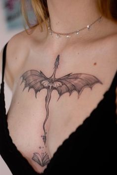 a woman with a dragon tattoo on her chest