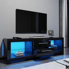 an entertainment center with blue lights and a flat screen tv