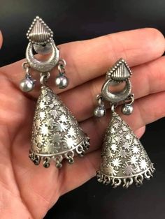 Great, silver-colored metal earrings - beautiful yumka carved with floral motifs. Small bells next to the earwires. Length 5.5 cm, diameter 2.5 cm. Metal Earrings With Intricate Design For Festivals, Metal Earrings With Intricate Design For Diwali, Intricate Metal Earrings For Diwali, Elegant Silver Danglers For Navratri, Ornate Oxidized Earrings For Festive Occasions, Ornate Oxidized Finish Earrings For Festive Occasions, Ornate Jhumkas For Pierced Ears, Ornate Oxidized Finish Festive Earrings, Ornate Metal Jhumkas For Gifts