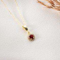 Elegant Gold Ruby Necklace A symbol of passion and vitality, our dainty ruby necklace is more than just an accessory--it's a statement. Crafted with attention to detail, the luminescent ruby pendant set in gold brings forth a touch of elegance and sophistication. Features: Genuine Ruby Gem: Handpicked for its radiant hue, our ruby pendant showcases the deep allure of this July birthstone. Gold Chain: Paired with a high-quality gold chain, the ruby pendant rests delicately, making it perfect for Dainty Ruby Necklace For Gift, Dainty Ruby Necklace As Gift, Gift Ruby Necklace With Delicate Chain, Ruby Necklace With Delicate Chain For Gift, Ruby Necklace With Delicate Chain As Gift, Dainty Ruby Pendant Necklace, Ruby Round Pendant Necklace For Gifts, Ruby Pendant Set, Gold Ruby Necklace