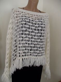 White poncho, crocheted, soft yarn one size One Size Knit Poncho With Fringe, Bohemian Open Knit Poncho One Size, One Size Bohemian Open Knit Poncho, One Size Knitted Poncho For The Beach, Beach Poncho In Open Knit One Size, Beach Poncho With Open Knit One Size, Beach Open Knit Poncho One Size, Cozy One Size Poncho For Beach, White Knitted One-size Poncho