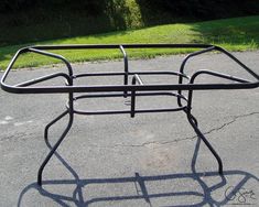 a metal rack sitting on the side of a road