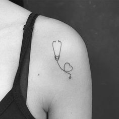 a woman with a stethoscope tattoo on her shoulder