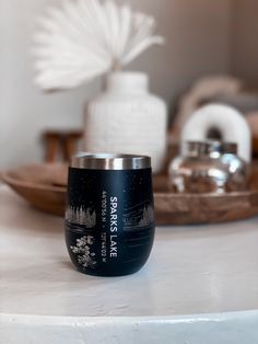 a black and silver cup sitting on top of a white counter