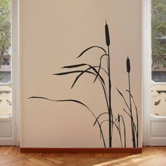 the wall is decorated with black reeds in front of an open window and wooden floor