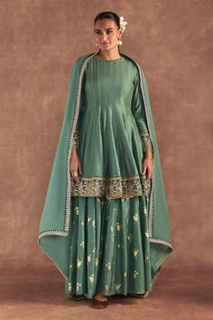 Moss green anarkali edged with kinari and embellished with border. Comes with irisbud foil printed sharara edged with kinari and a printed dupatta.
Components: 3
Pattern: Foil Printed, Embroidered
Type Of Work: Irisbud
Neckline: Round
Sleeve Type: Full
Fabric: Anarkali and Sharara- Raw Silk, Dupatta- Organza
Color: Green
Other Details: 
Disclaimer: The actual print-placement and colour of the product may vary slightly from the image shown.
Occasion: Sangeet - Aza Fashions Short Anarkali Suits, Green Sharara, Printed Sharara, Mom Dresses, Green Anarkali, Sharara Designs, Choli Dress, Happy Dresses, Traditional Attires