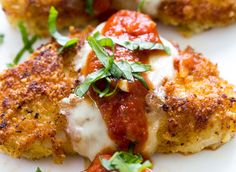 chicken parmesan with tomato sauce and fresh herbs