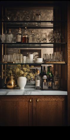 an assortment of glasses and bottles on shelves