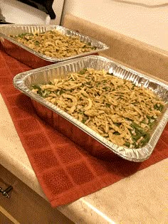 two pans filled with food sitting on top of a counter