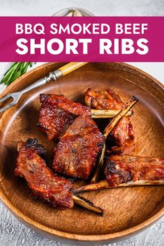 bbq smoked beef short ribs on a wooden plate with skewered toothpicks