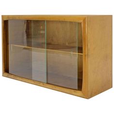 a wooden cabinet with glass doors and shelves