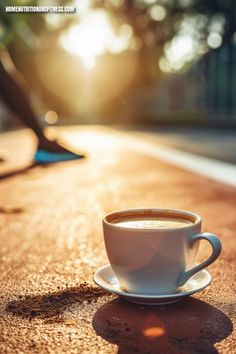 a cup of coffee sitting on top of a wooden table