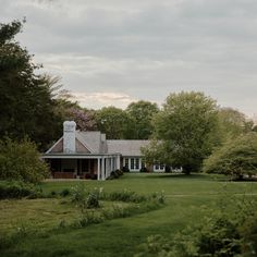 the house is surrounded by trees and grass