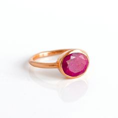 You'll fall in love with the deep red color of this Dyed Ruby ring. This is a perfectly sized oval to compliment any collection. Popular as a birthday gift for those July babes and ruby lovers alike. This is a natural stone that is lab-dyed a deep red-magenta color. There are natural inclusions and variations so no two stones are exactly alike. This is an opaque gemstone with naturally occurring inclusions. This stone is beautifully faceted and bezel set in a 925 sterling silver band or plated w Red Oval Cabochon Ruby Ring For Gift, Oval Cabochon Ruby Ring Birthstone Gift, Oval Ruby Ring With Large Stone For Gift, Oval Cabochon Ruby Ring, Valentine's Day Oval Ruby Ring, Oval Cabochon Ruby Ring Gift, Oval Ruby Rings For Gift, Oval Red Gemstone Birthstone Ring, Oval Ruby Rings Suitable For Gifts