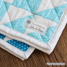 two blue and white quilts sitting on top of each other