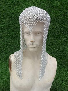 a white mannequin with chains on it's head