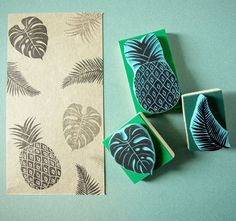 three rubber stamps with pineapples and palm leaves on them next to a piece of paper