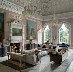 a living room filled with furniture and a fire place in the middle of a room