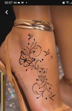 a woman's foot with an owl and butterfly tattoo on it, sitting next to a pair of high heels