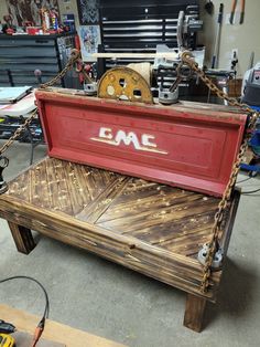 a bench made out of wood and rope with the word cmc on it's back